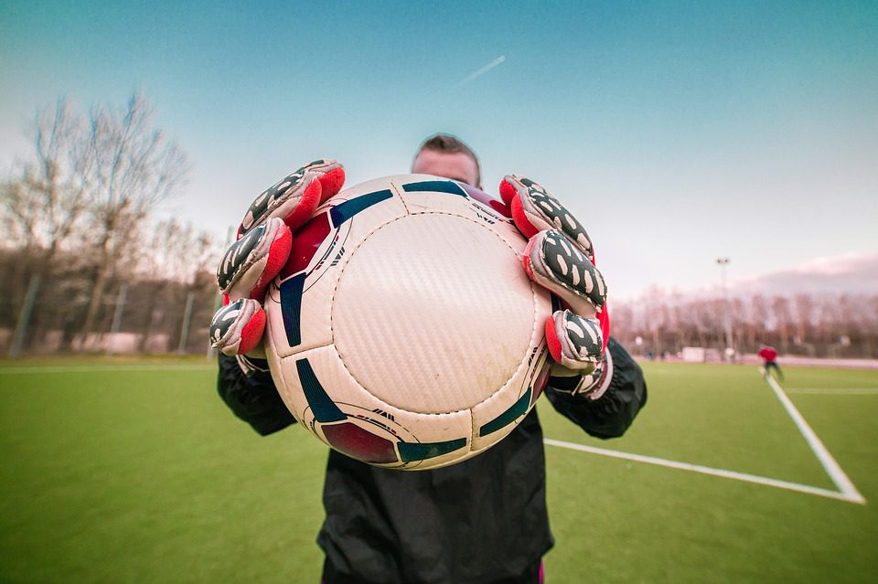 a goalkeeper holding a ball