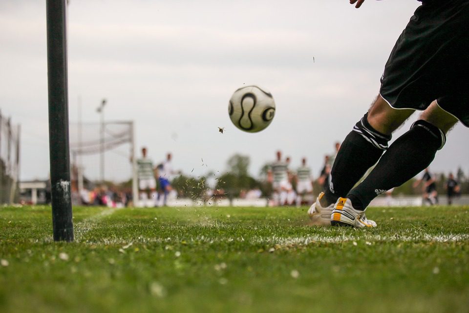 footballer kicking the ball